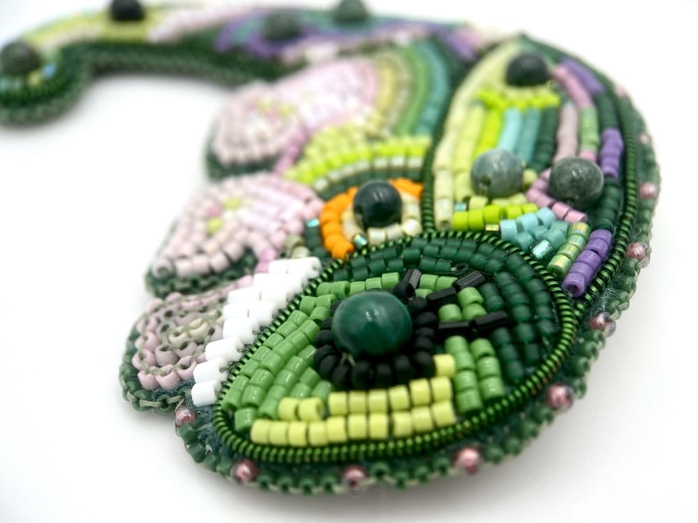 Handmade beaded brooch in the shape of a colorful chameleon