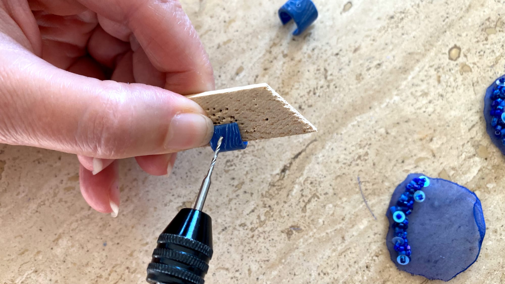 Make a hole at both edges of the polymer clay element.