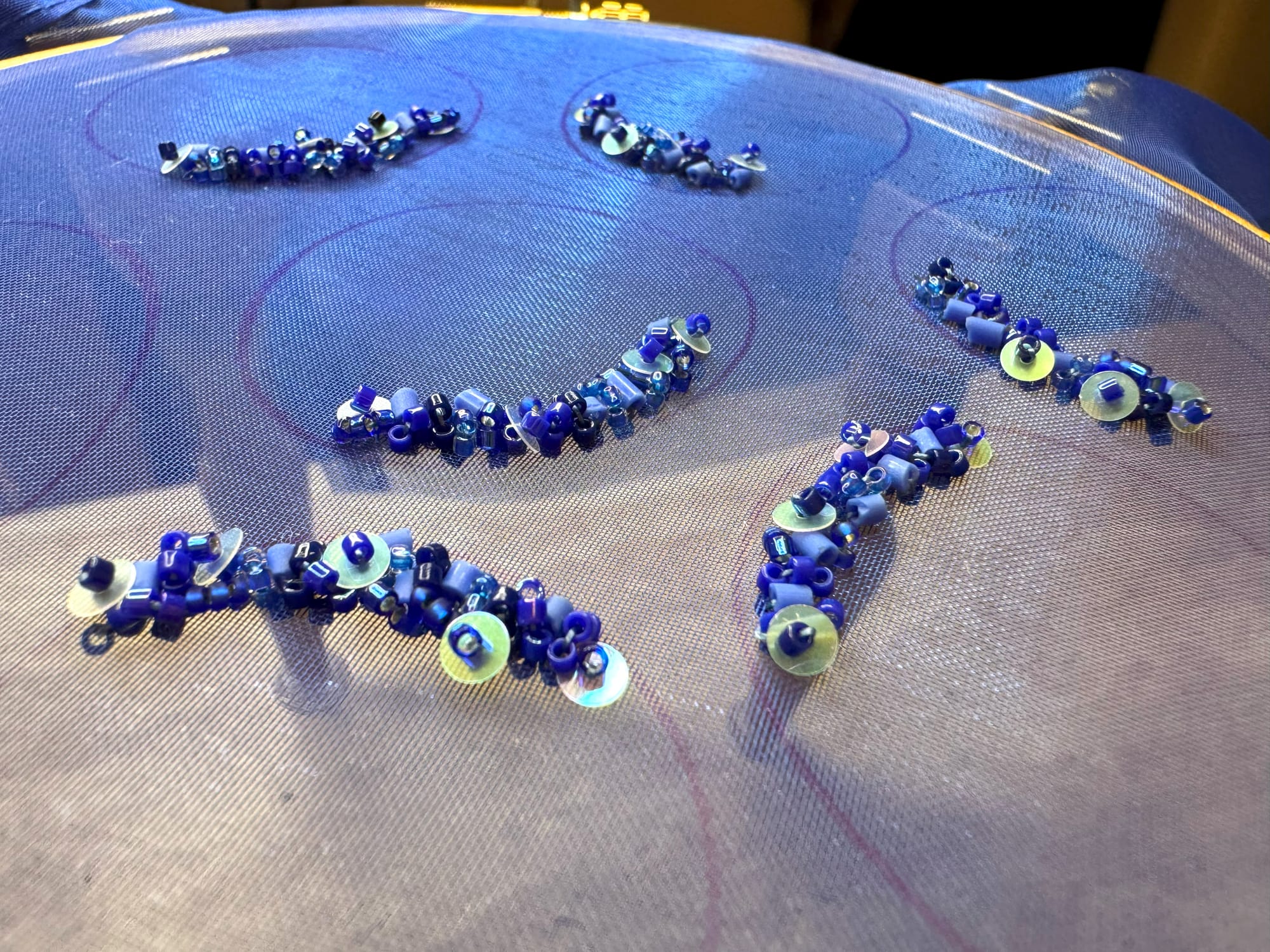 Six petals embroidered with beads. In this photo, you can see the edges marked by a pen.