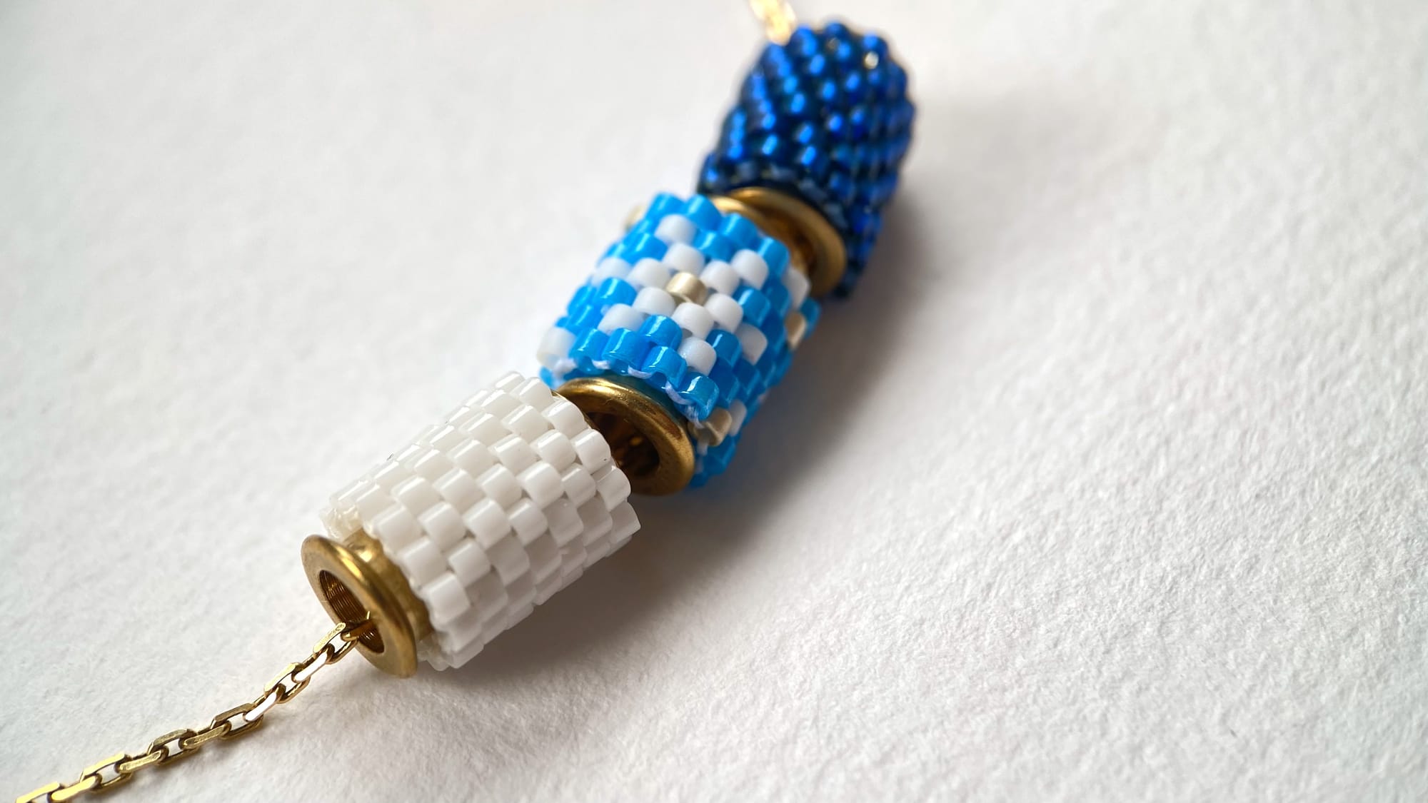 Handmade beaded pendants featuring snowflake ornament