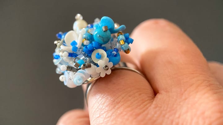 Floral ring made in 3D-beading technology from beads, sequins, and stones.